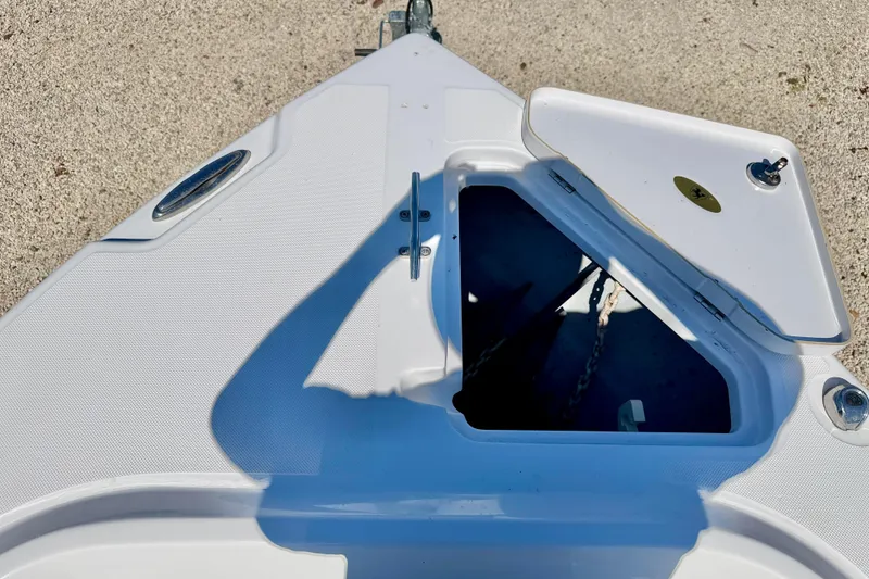 Slide: The Image of Open hatch on 2022 Century 2301 Center Console boat deck, showing anchor storage. - 32