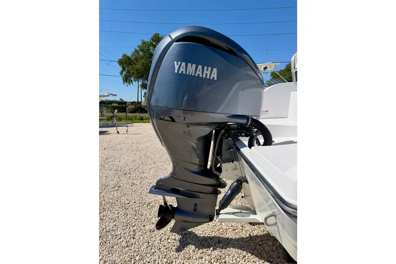 Slide: The Image of Yamaha outboard motor on 2022 Century 2301 Center Console boat, parked on gravel. - 33