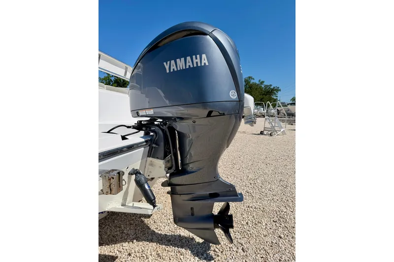 Slide: The Image of Yamaha outboard motor on 2022 Century 2301 Center Console boat, parked on gravel. - 35