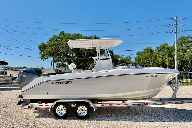 Slide: The Image of 2022 Century 2301 Center Console boat on trailer, featuring Yamaha engine, parked outdoors. - 4
