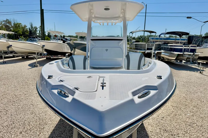 Slide: The Image of 2022 Century 2301 Center Console boat displayed in a sunny outdoor showroom. - 8