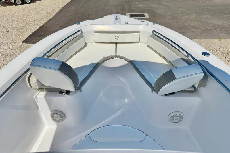 Slide: The Image of 2022 Century 2301 Center Console boat interior with cushioned seating and speakers. - 9