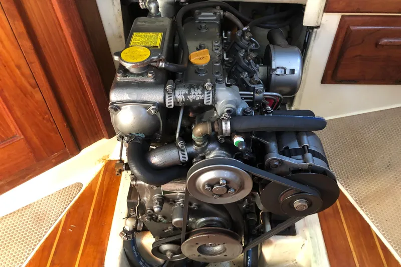 Slide: The Image of Engine of a 1988 Pacific Seacraft 31 sailboat, showcasing mechanical components and belts. - 13