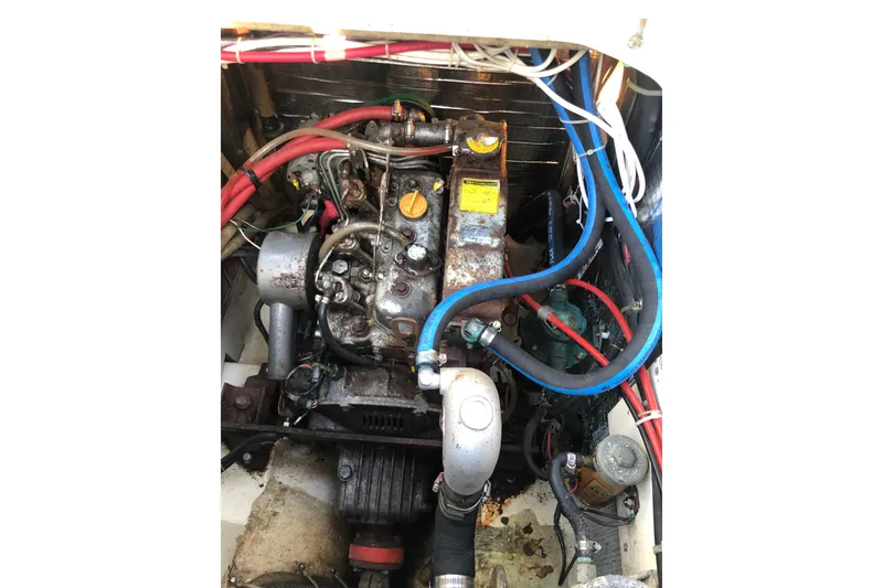 Slide: The Image of Engine compartment of a 1988 Pacific Seacraft 31 sailboat, showing hoses and components. - 14
