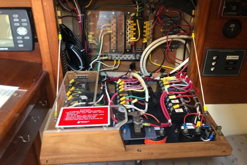 Slide: The Image of Electrical panel of a 1988 Pacific Seacraft 31 sailboat, showcasing wiring and circuit components. - 15