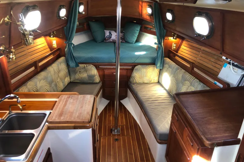 Slide: The Image of Interior of 1988 Pacific Seacraft 31 sailboat with cozy seating and wooden finishes. - 4