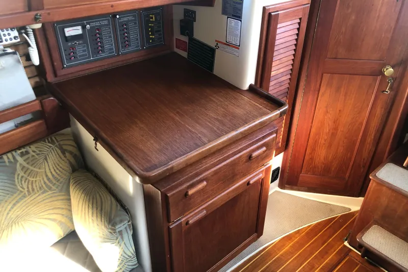 Slide: The Image of 1988 Pacific Seacraft 31 interior with wooden cabinetry and control panels. - 7