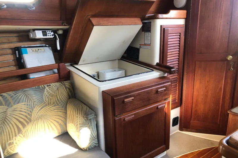 Slide: The Image of Interior of 1988 Pacific Seacraft 31 sailboat with wooden cabinetry and seating area. - 8