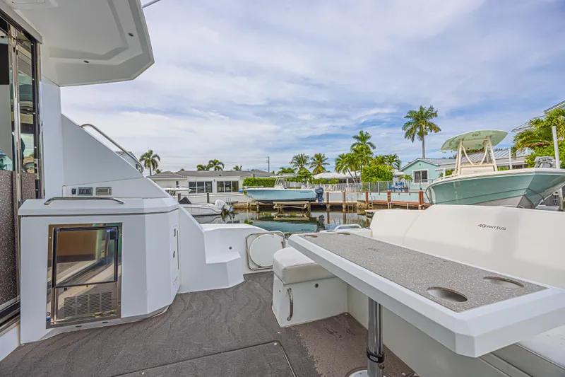 Slide: The Image of 2012 Cruisers Yachts 48 Cantius docked, featuring spacious deck and modern amenities. - 17