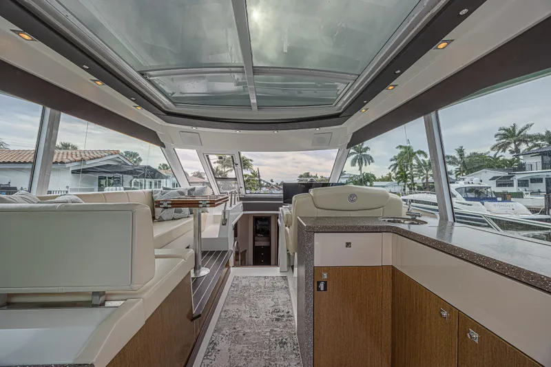Slide: The Image of Luxurious interior of 2012 Cruisers Yachts 48 Cantius with panoramic windows and elegant seating. - 18