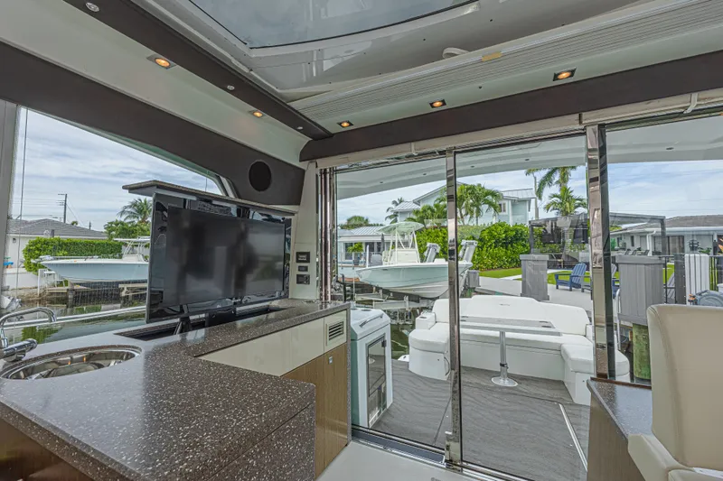 Slide: The Image of Interior view of 2012 Cruisers Yachts 48 Cantius with TV and outdoor seating area. - 20