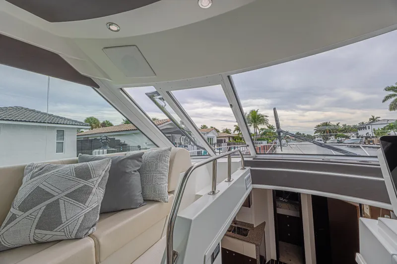 Slide: The Image of Interior view of 2012 Cruisers Yachts 48 Cantius, featuring plush seating and large windows. - 24