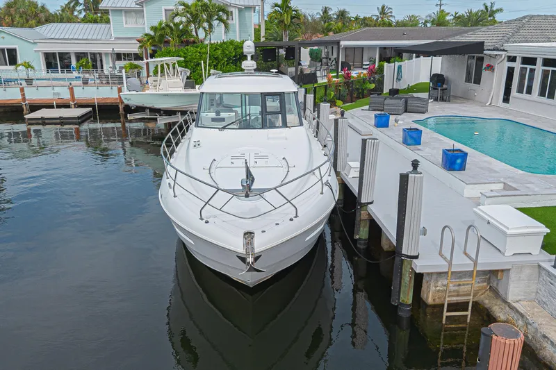 Slide: The Image of 2012 Cruisers Yachts 48 Cantius docked by a luxurious waterfront home. - 3