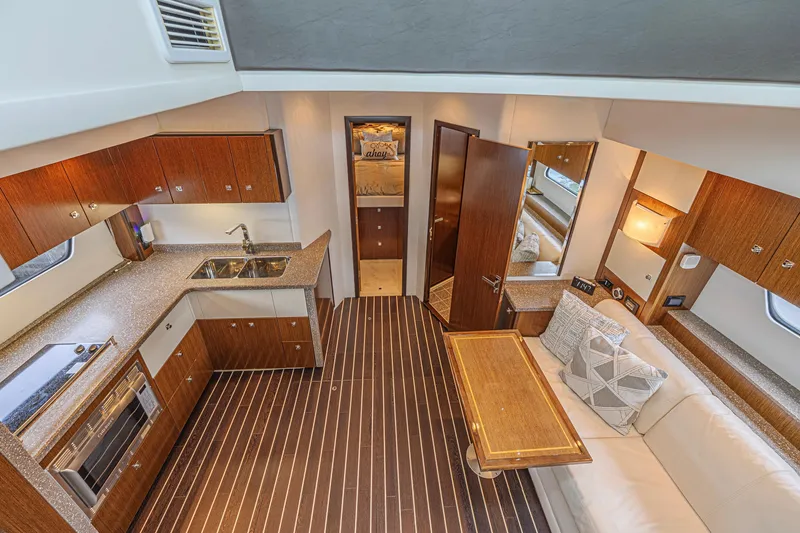 Slide: The Image of Luxurious interior of 2012 Cruisers Yachts 48 Cantius with modern kitchen and cozy seating area. - 31