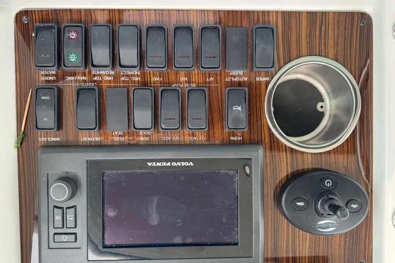 Slide: The Image of Control panel of 2012 Cruisers Yachts 48 Cantius with switches and Volvo Penta display. - 43