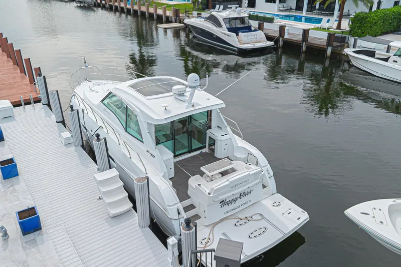 Slide: The Image of 2012 Cruisers Yachts 48 Cantius docked in a serene marina setting. - 5