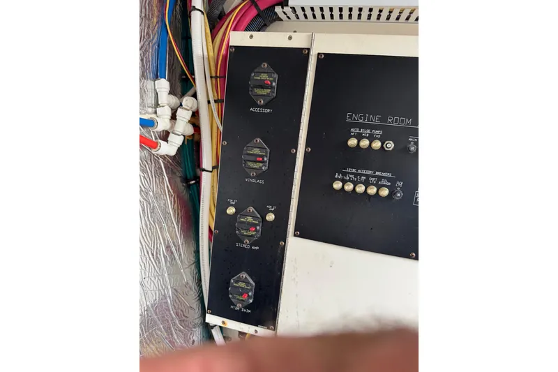 Slide: The Image of Engine room control panel of 2012 Cruisers Yachts 48 Cantius with switches and wiring. - 54