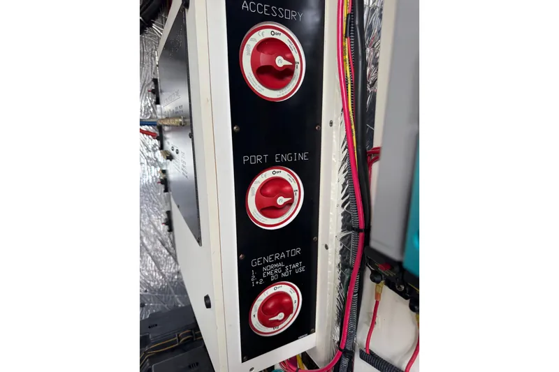 Slide: The Image of Control panel with red switches on a 2012 Cruisers Yachts 48 Cantius. - 55