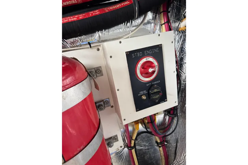 Slide: The Image of Engine control panel on 2012 Cruisers Yachts 48 Cantius, featuring battery charger and wiring. - 57