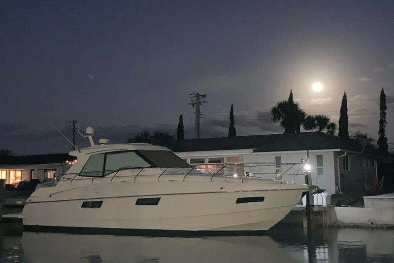 Slide: The Image of 2012 Cruisers Yachts 48 Cantius docked at night under a full moon. - 8