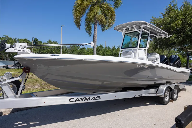 The Image of 2022 Caymas 28 HB Twin boat on trailer, parked under a clear blue sky. - 0