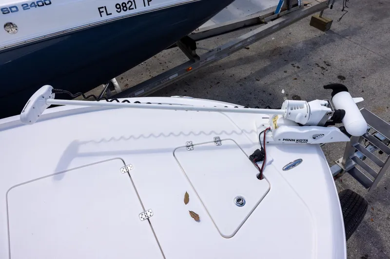 Slide: The Image of 2022 Caymas 28 HB Twin boat with Minn Kota trolling motor on deck. - 17