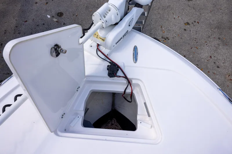 Slide: The Image of 2022 Caymas 28 HB Twin boat with open storage compartment and trolling motor. - 19