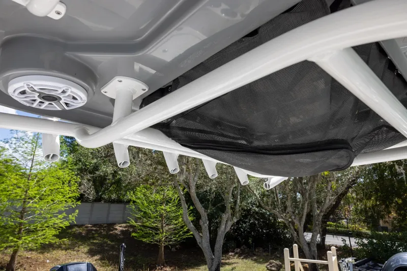 Slide: The Image of 2022 Caymas 28 HB Twin boat with rod holders and speaker, outdoor setting. - 21