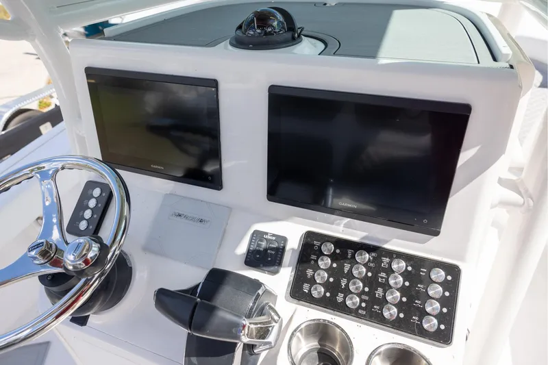 Slide: The Image of Helm of 2022 Caymas 28 HB Twin with dual Garmin displays and control panel. - 23