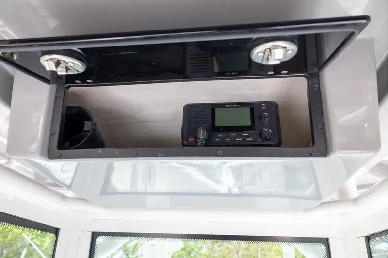 Slide: The Image of Storage compartment with Garmin device in 2022 Caymas 28 HB Twin boat. - 24