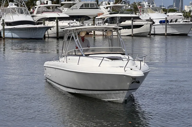 Slide: The Image of 2007 Intrepid 310 Walkaround boat docked in a marina with other vessels. - 1