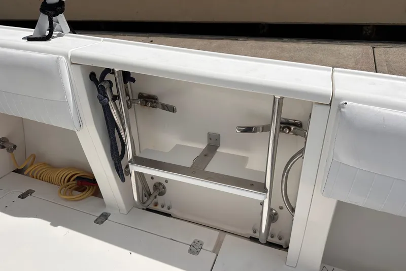 Slide: The Image of 2007 Intrepid 310 Walkaround boat interior with ladder and storage compartment. - 12