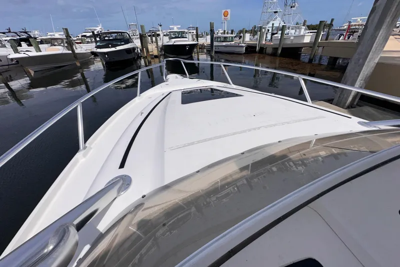 Slide: The Image of 2007 Intrepid 310 Walkaround boat docked at marina, view from bow. - 14