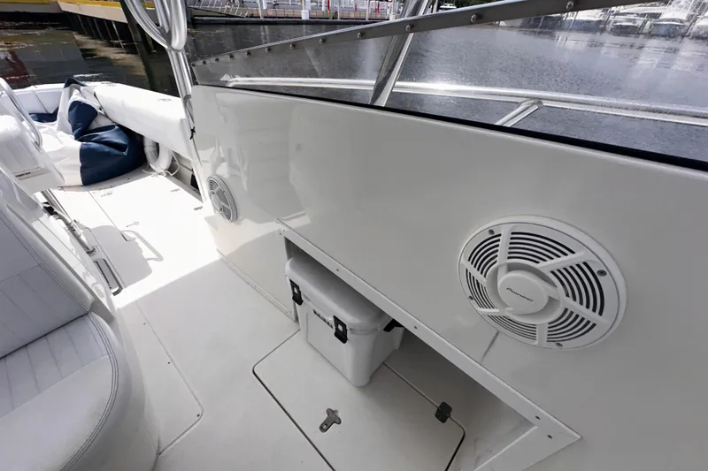 Slide: The Image of 2007 Intrepid 310 Walkaround boat interior with speaker and storage compartment. - 15