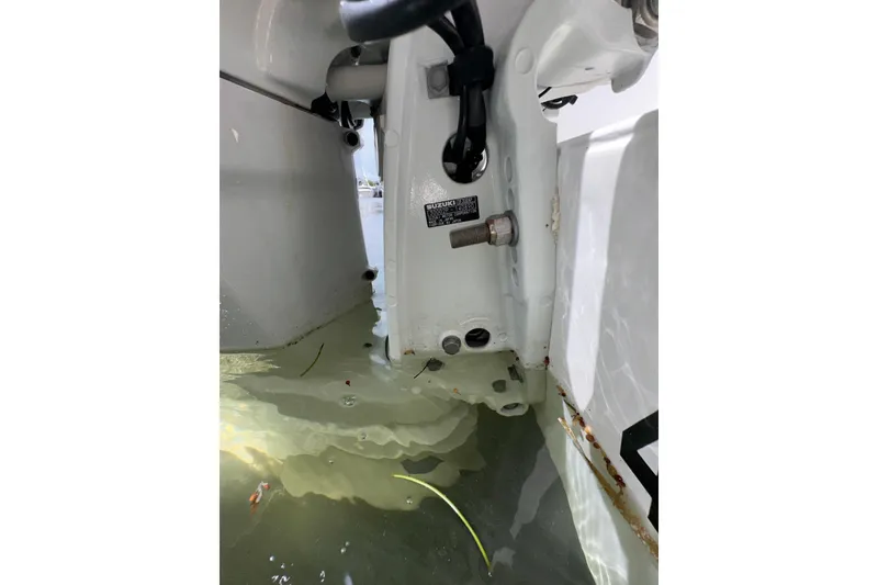 Slide: The Image of Close-up of a 2007 Intrepid 310 Walkaround boat engine in water. - 17