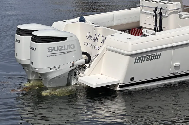 Slide: The Image of 2007 Intrepid 310 Walkaround boat with twin Suzuki 300 outboard engines on water. - 4
