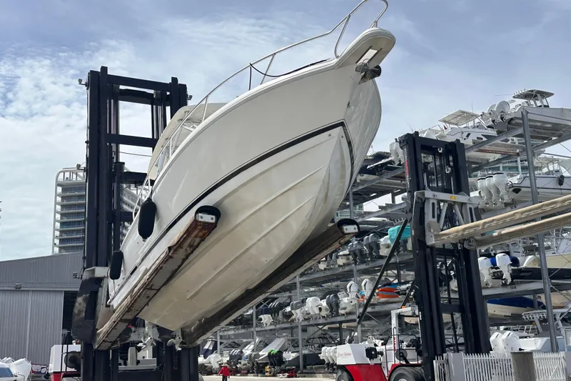 Slide: The Image of 2007 Intrepid 310 Walkaround boat lifted by forklift in marina storage facility. - 5