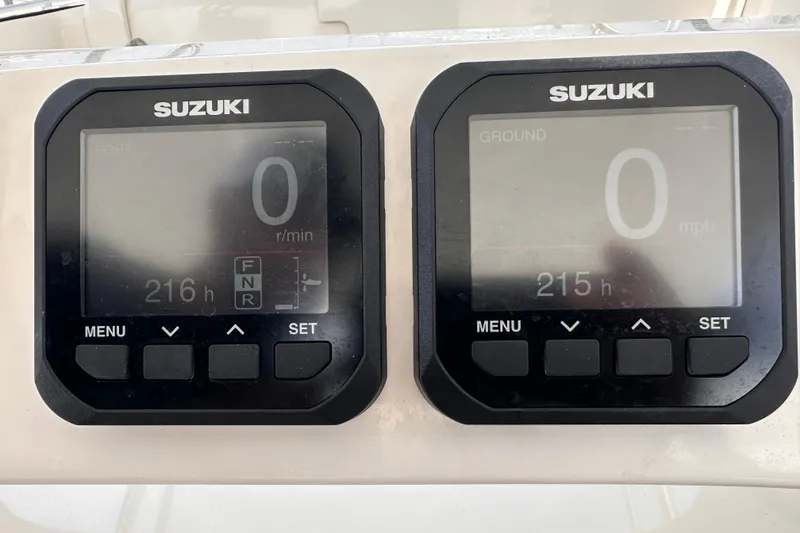 Slide: The Image of Suzuki digital gauges on a 2007 Intrepid 310 Walkaround boat dashboard. - 8