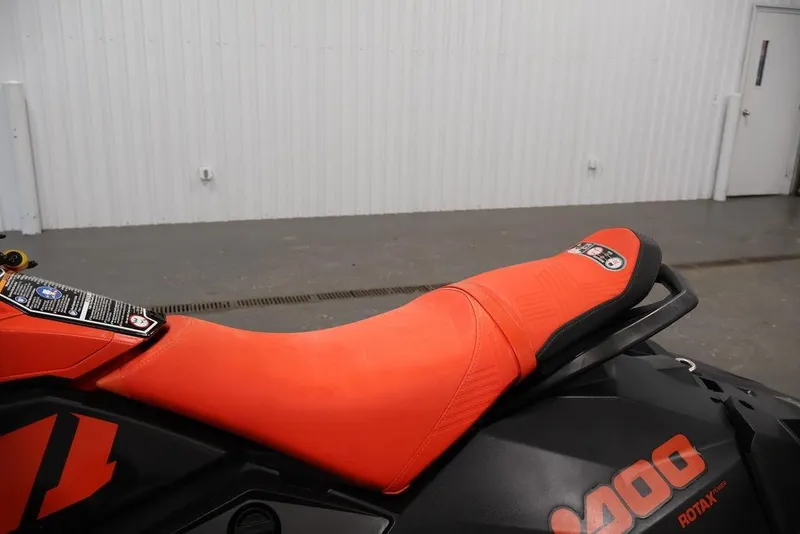 Slide: The Image of 2022 Sea-Doo Spark for 2, featuring a vibrant orange seat in a showroom setting. - 11