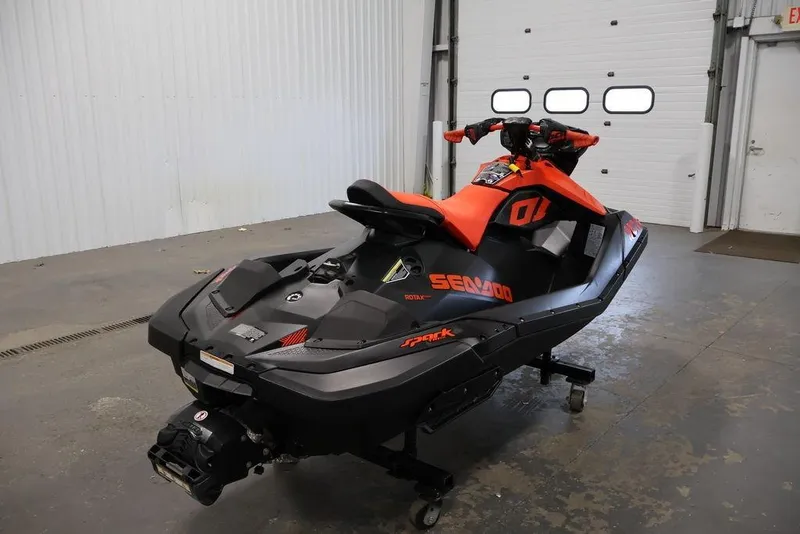 Slide: The Image of 2022 Sea-Doo Spark for 2 jet ski in a garage setting. - 12