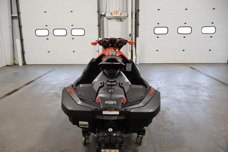 Slide: The Image of 2022 Sea-Doo Spark for 2 jet ski in a garage, rear view. - 14