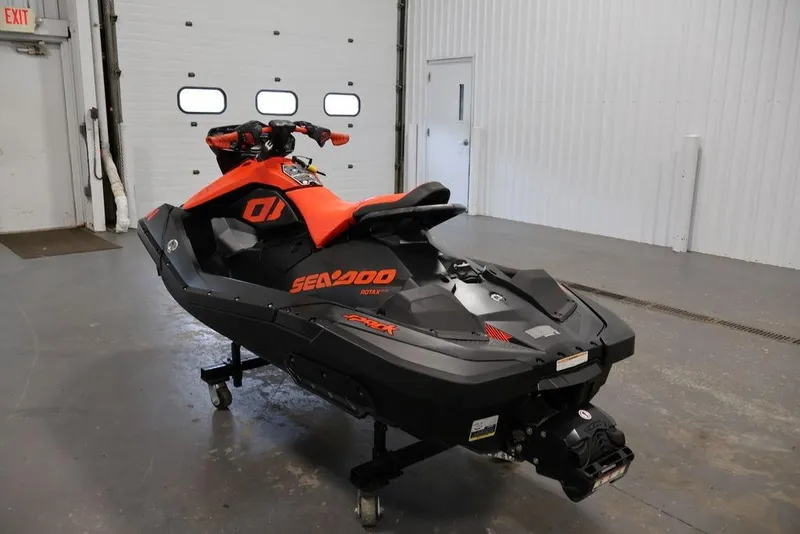 Slide: The Image of 2022 Sea-Doo Spark for 2 jet ski in a garage setting. - 3