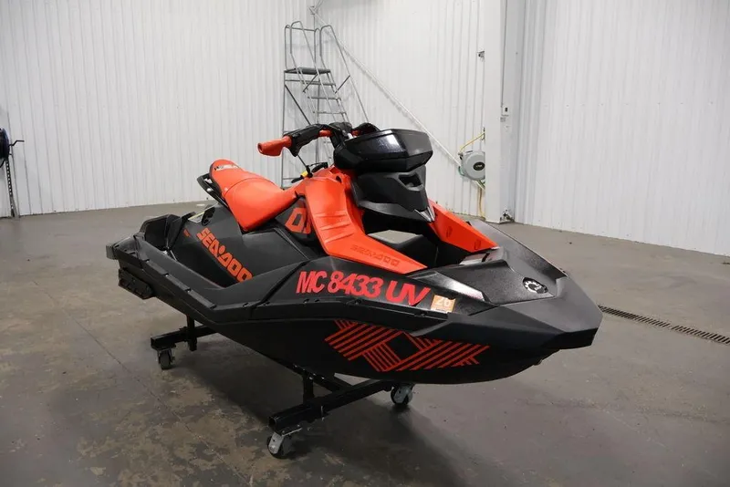 Slide: The Image of 2022 Sea-Doo Spark for 2 jet ski in a garage setting. - 4