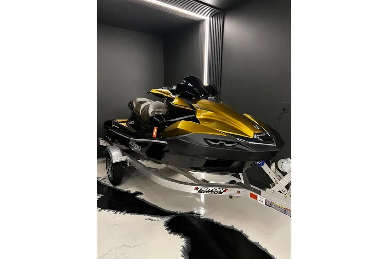 The Image of 2023 Kawasaki Jetski Ultra 310LX in a sleek showroom, displayed on a Triton trailer. - 1