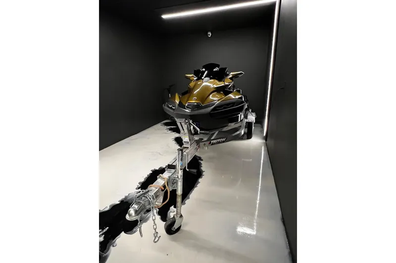 Slide: The Image of 2023 Kawasaki Jetski Ultra 310LX on trailer in sleek, modern garage setting. - 13