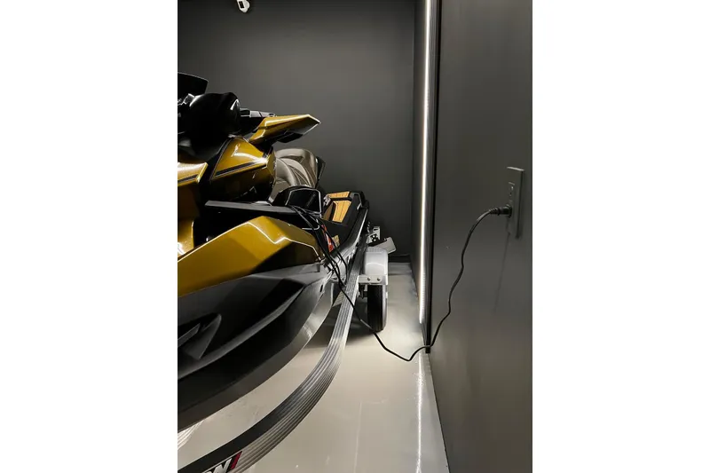 Slide: The Image of 2023 Kawasaki Jetski Ultra 310LX in a dimly lit garage, plugged into a wall outlet. - 5