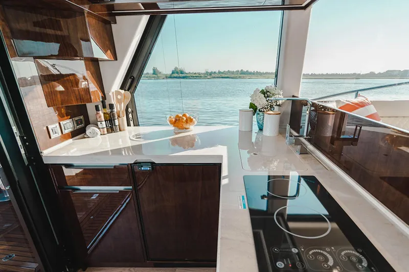 Slide: The Image of Luxurious kitchen interior of 2024 Galeon 470 Sky yacht with scenic water view. - 9