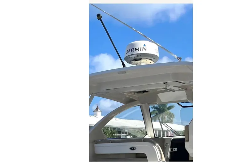 Slide: The Image of 2016 Pursuit OS 325 Offshore boat with Garmin radar against blue sky. - 3