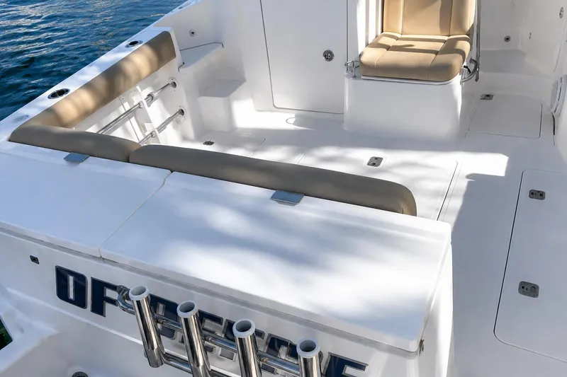 Slide: The Image of 2016 Pursuit OS 325 Offshore boat deck with seating and rod holders. - 4