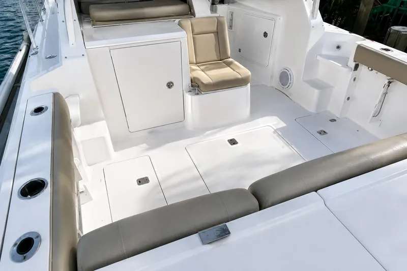 Slide: The Image of 2016 Pursuit OS 325 Offshore boat interior with cushioned seating and storage compartments. - 6